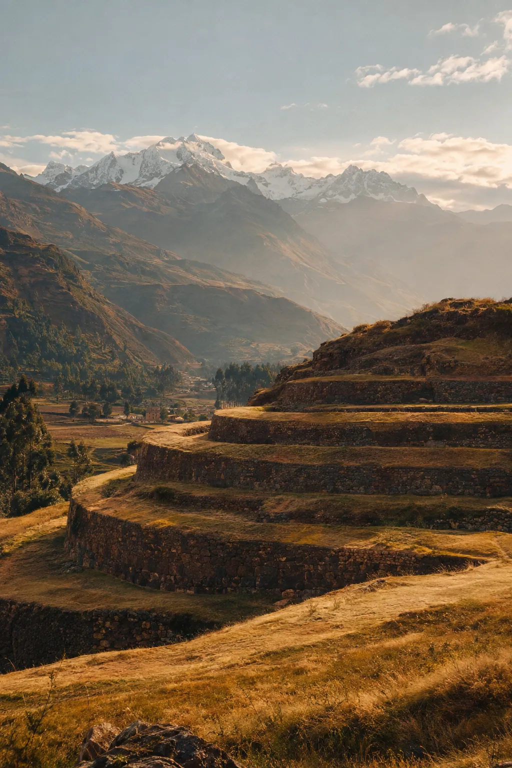 Ancient Inca terraces in the Sacred Valley glowing in late-afternoon light beneath snowy peaks